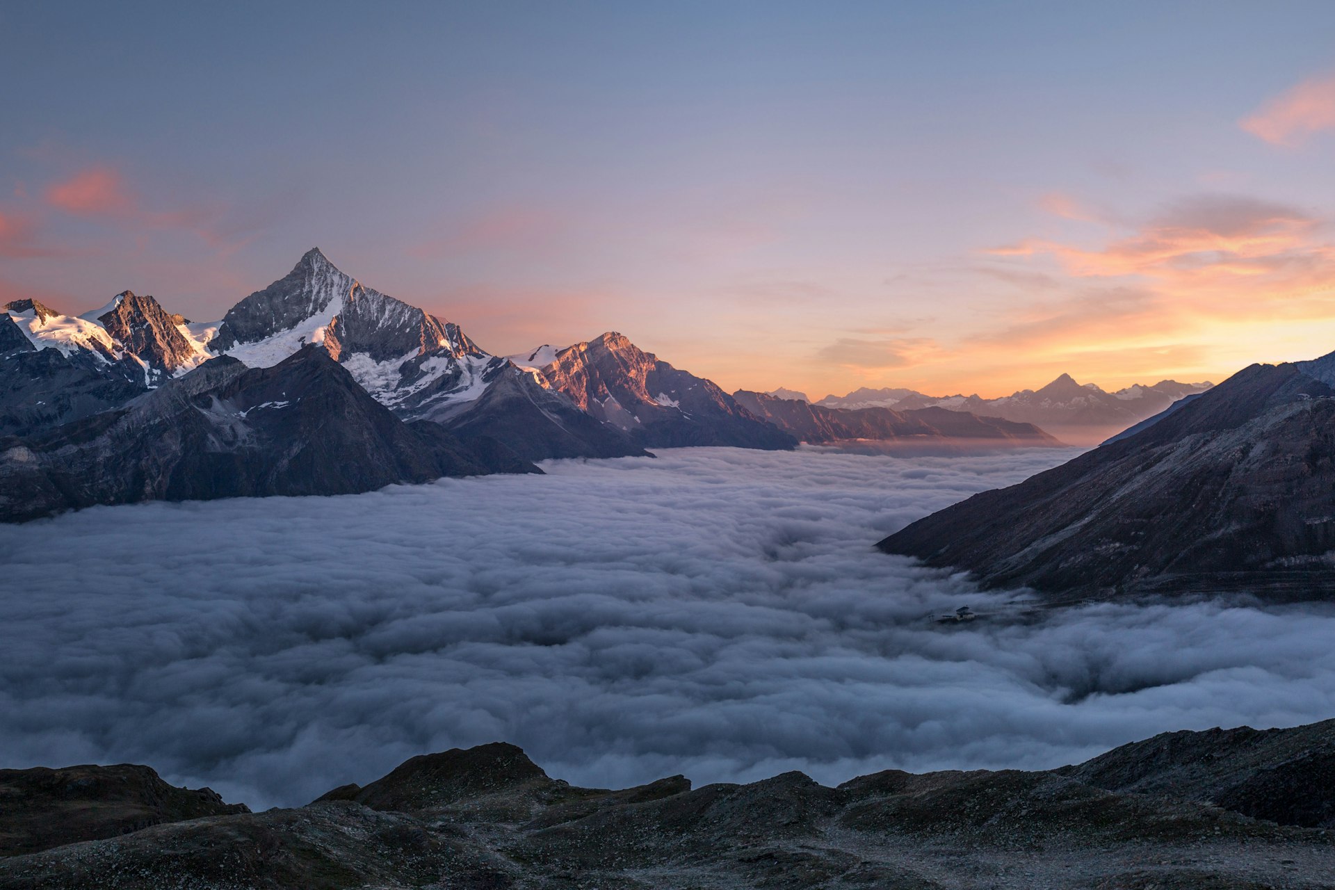 Snow-capped mountain peaks under a wide open sky